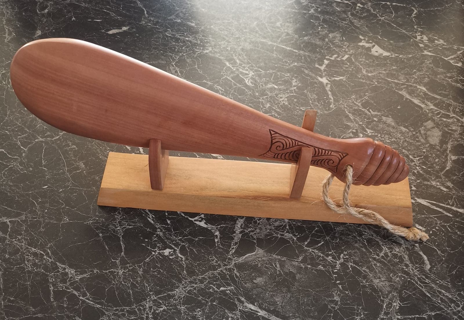 Wooden Patu on stand — view 1